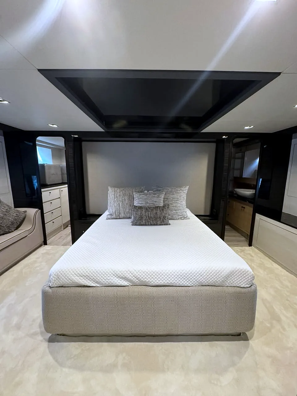 Double-bed stateroom centered under a dark ceiling