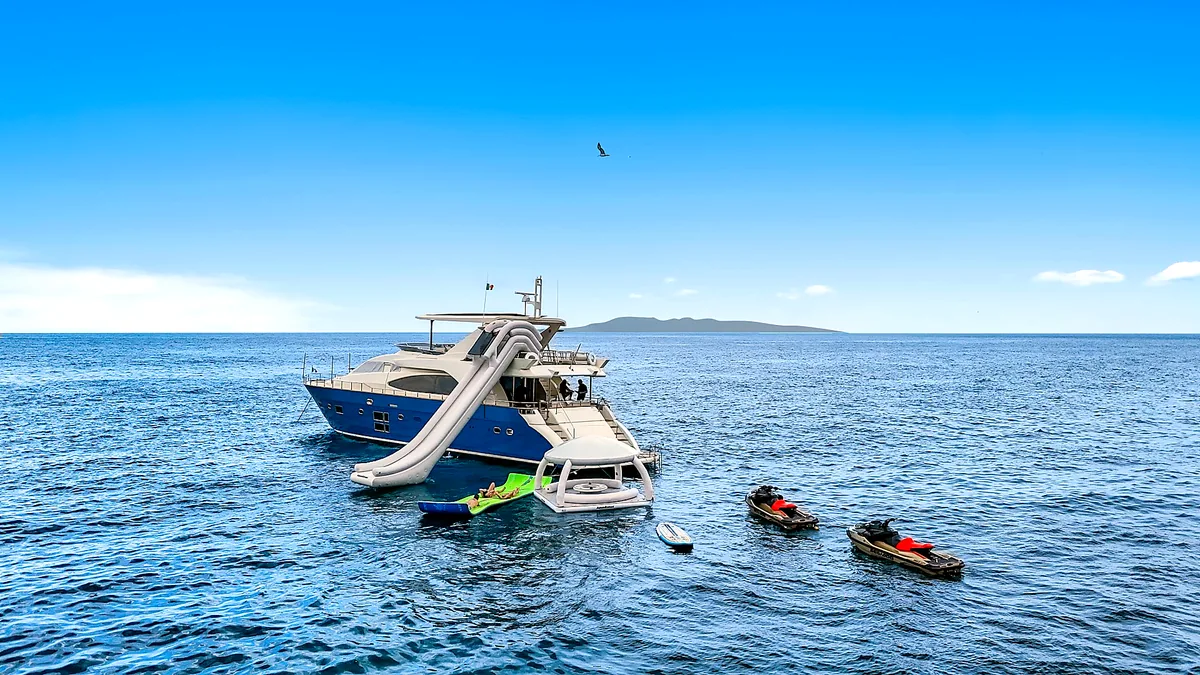 Water slide, floating lounge and jet skis beside MÍO